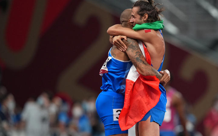 Italy's Lamont Marcell Jacobs, left, and Gianmarco Tamberi celebrate their Olympic gold medals.