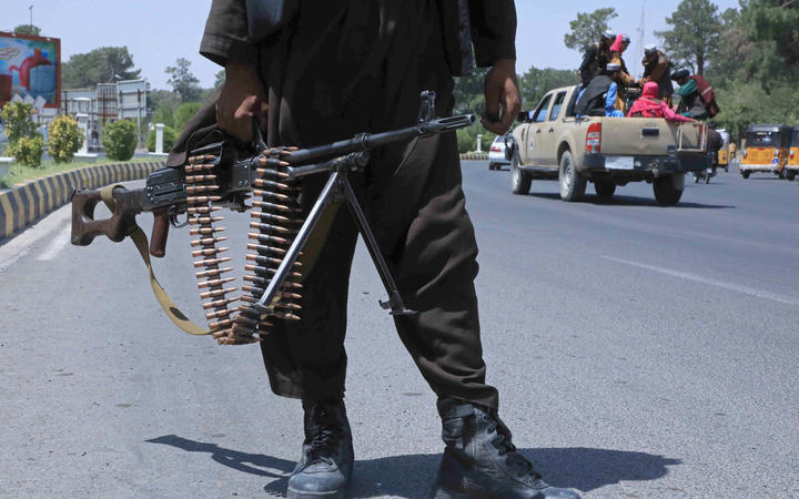 A Taliban fighter stands guard on a street in Herat on August 14, 2021.