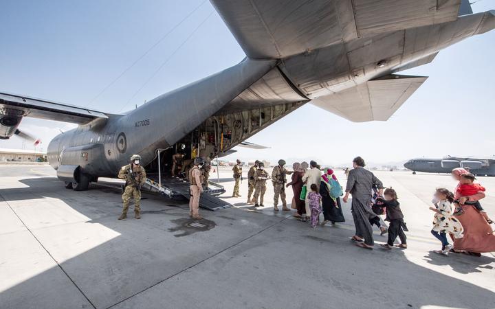 People boarding the Hercules C-130 at Hamid Karzai International Airport.