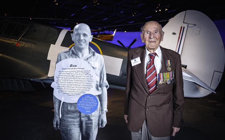 Ron Hermanns standing with a cutout figure of his younger self at the New Zealand Air Force Museum in 2019.