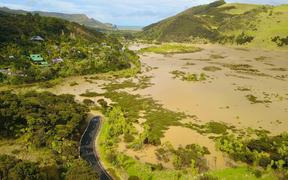 Residents of Te Henga Bethells Beach have no access to the only road out of the area after flooding in the area.