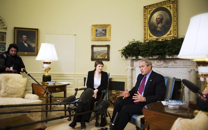 US President George W. Bush (R) speaks to the press during a meeting with New Zealand Prime Minister Helen Clark 21 March 2007 in the Oval Office.