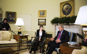 US President George W. Bush (R) speaks to the press during a meeting with New Zealand Prime Minister Helen Clark 21 March 2007 in the Oval Office.