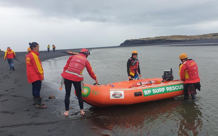 Surf lifesaving teams from Raglan and Taranaki prepare to enter the water at Marokopa to start a coastline search from the ocean.