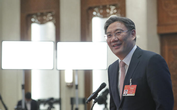 Chinese Minister of Commerce Wang Wentao prepares to leave after giving an interview via video link following the second plenary meeting of the fourth session of the 13th National People's Congress (NPC) in Beijing, capital of China, March 8, 2021.