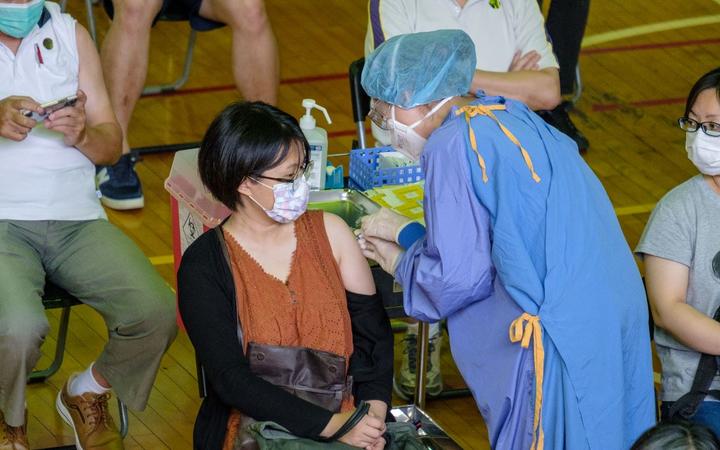 A person seen getting her first dose of Taiwanese home grown COVID-19 vaccine developed by Medigen Vaccine Biologics Corp. in Taipei , Taiwan, 23 June 2021.
