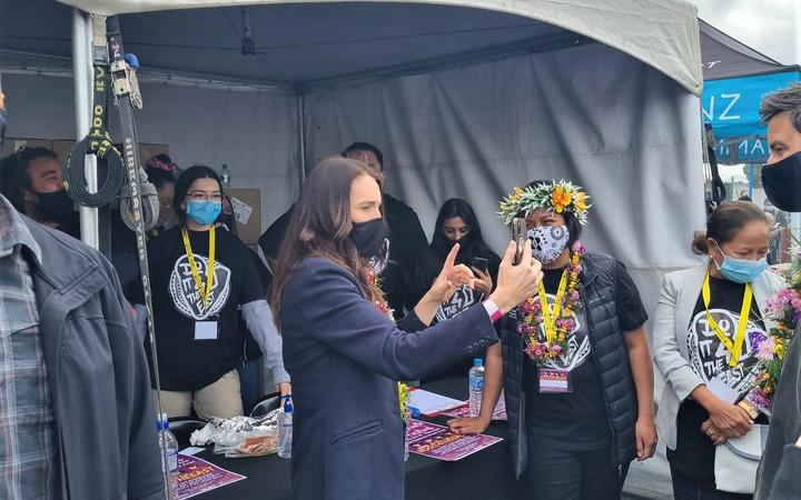 Prime Minister Jacinda Ardern taking a selfie with some of the organizers of ‘Do it 4 the East’, a youth-led vaccination event in Porirua. 