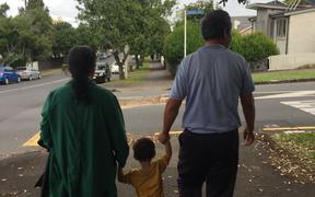 Helen Zhao's parents and their granddaughter taking a walk in Auckland.