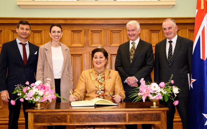 WELLINGTON, NEW ZEALAND - October 21: The Governor General Dame Cindy Kiro signs the guest book with Clarke Gayford, Jacinda Ardern, Dr Richard Davies, Trevor Mallard. wearing-in ceremony of Dame Cindy Kiro October 21, 2021 in Wellington