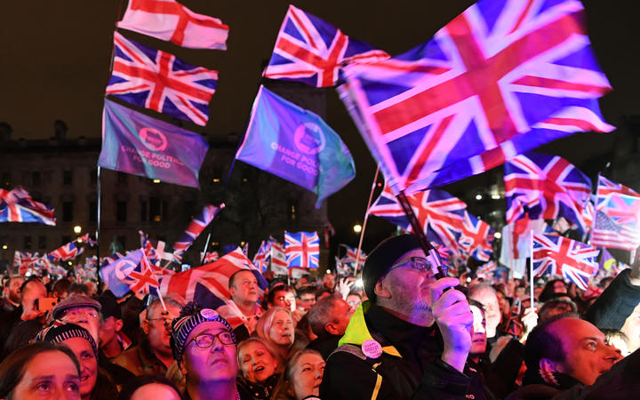 Brexit supporters wave Union flags as they watch the big screen in Parliament Square, venue for the Leave Means Leave Brexit Celebration party in central London.