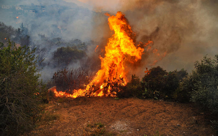 A handout picture released by the official Syrian Arab News Agency (SANA) on October 10, 2020 shows a fire devouring a forest in Syria's Latakia province the previous day.