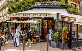  Waiters wear masks at a famous Parisian cafe on 19 May, 2021, a day after lockdown due to Covid-19.