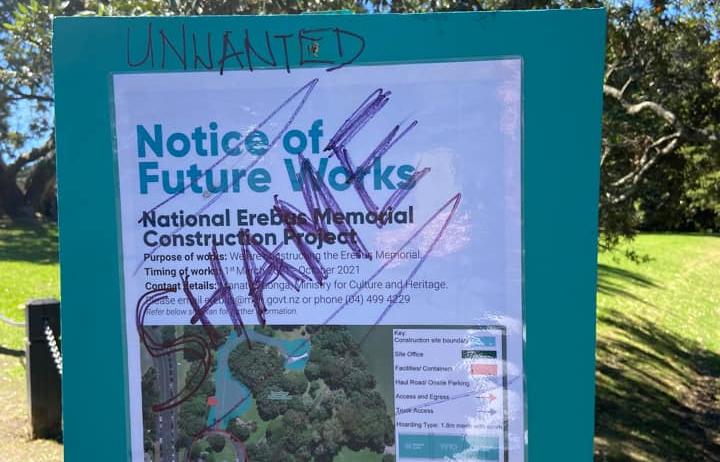 A defaced sign announcing the commencement of construction of the Erebus memorial in a Parnell park.