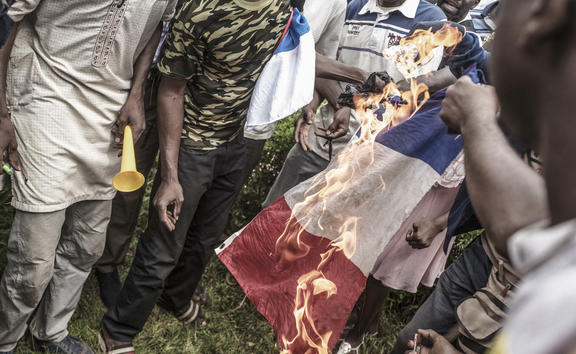 Protesters burn a French flag in Bamako during a demonstration against French influence in the country.