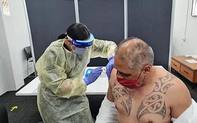 Associate Health Minister Peeni Henare receives his booster shot of the Pfizer vaccine from Tūwharetoa Ki Kawerau Hauora nurse Puaawai Te Pou. 