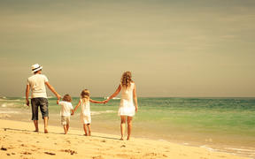 Family walking at the beach.