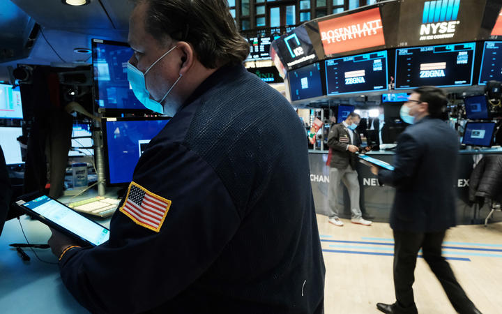 A trader works on the floor of the New York Stock Exchange (NYSE) on 20 December 2021. 