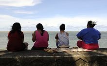 Samoan women gather on the waterfront in Apia. 