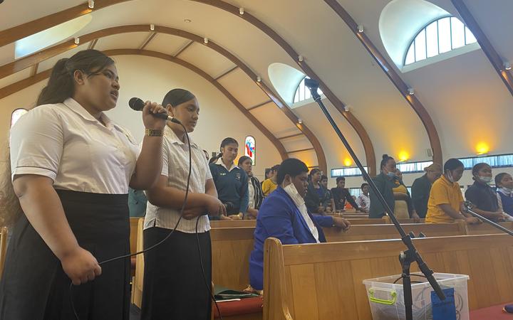 An Auckland church congregation prays for their family in Tonga.