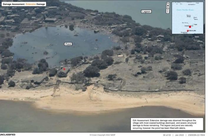 Nomuka Island in Ha'apai, Tonga, as seen from an NZDF P-3 Orion reconnaisance flight after the eruption of Hunga Tonga-Hunga Ha'apai. The image caption says extensive damage was observed through the village with most coastal buildings destroyed.