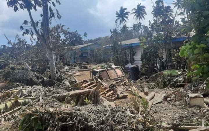 Ash and debris covering houses and a road in Nuku'alofa, Tonga.