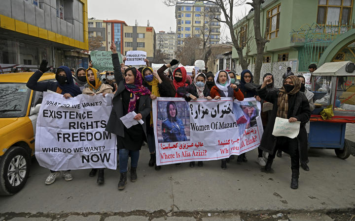 Afghan women march as they chant slogans and hold banners during a women's rights protest in Kabul on 16 January, 2022. 