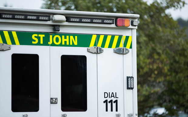 Close up of a St John ambulance on a residential street.