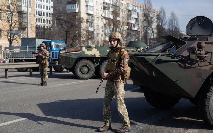KYIV, UKRAINE - FEBRUARY 25: Ukrainian servicemen stand on patrol at a security checkpoint on February 25, 2022 in Kyiv, Ukraine. 
