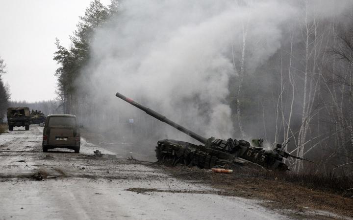 Smoke rises from a Russian tank destroyed by Ukrainian forces in Lugansk region on February 26, 2022.