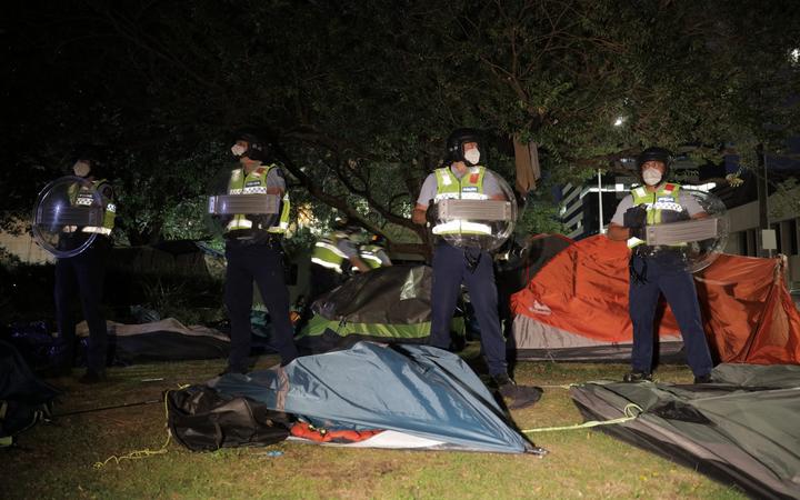 Police ripped down tents at the protest site in Wellington during an early morning operation.