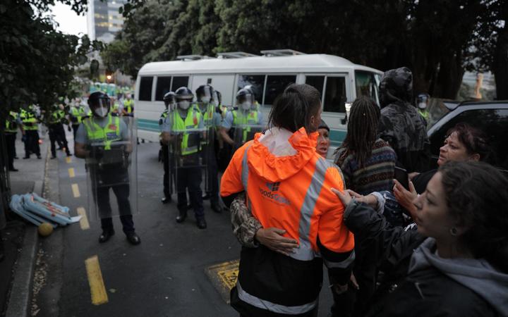 Police undertake an early morning operation to restore order and access to the area around Parliament.