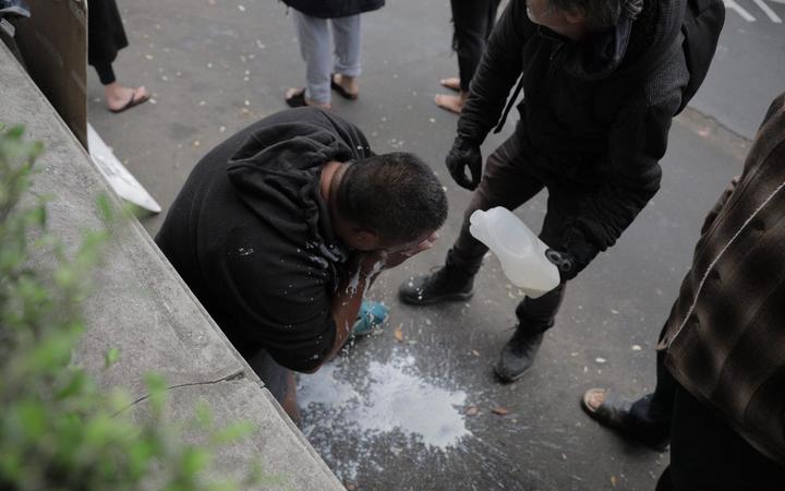 Milk poured over a protester.