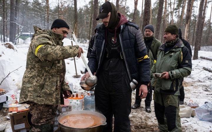 Ukrainian servicemen are seen outside of Kyiv on 1 March, 2022 - the sixth day of Russian attacks on Ukraine.