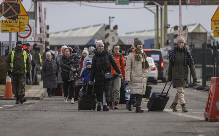 Refugees from Ukraine are pictured after crossing the Ukrainian-Polish border in Korczowa on March 02, 2022.