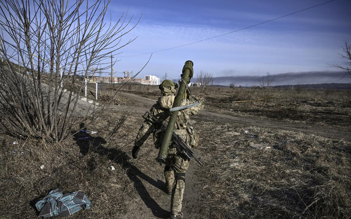 A Ukranian serviceman walks towards the front line in the city of Irpin, northern Ukraine, on 12 March 2022. 