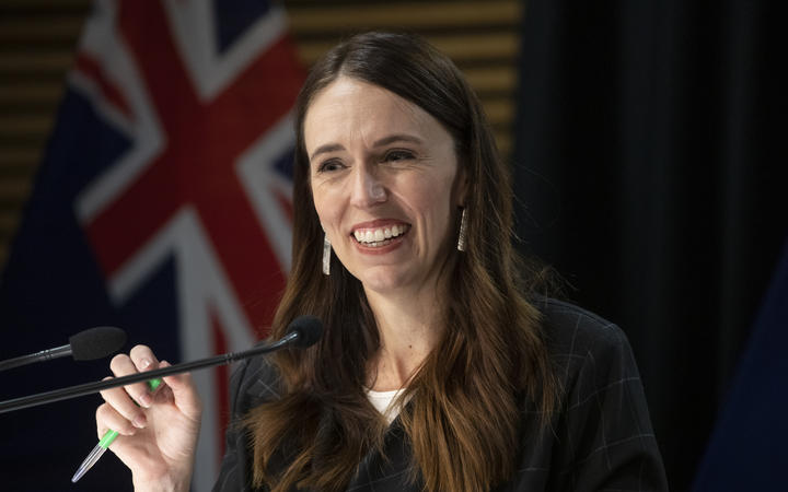 - POOL - Photo by Mark Mitchell.  Prime Minister Jacinda Ardern smiling during the post-Cabinet press conference with Energy Minister Megan Woods and Finance Minister Grant Robertson, Parliament, Wellington. 14 March, 2022.  NZ Herald photograph by Mark Mitchell