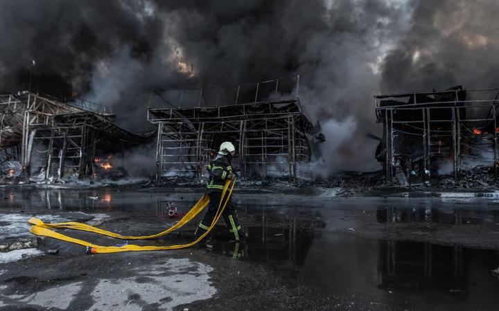 KHARKIV, UKRAINE - MARCH 16: Firefighters try to extinguish a fire broke out at the Saltivka construction market, hit by 6 rounds of Russian heavy artillery in Kharkiv, Ukraine on March 16, 2022. 