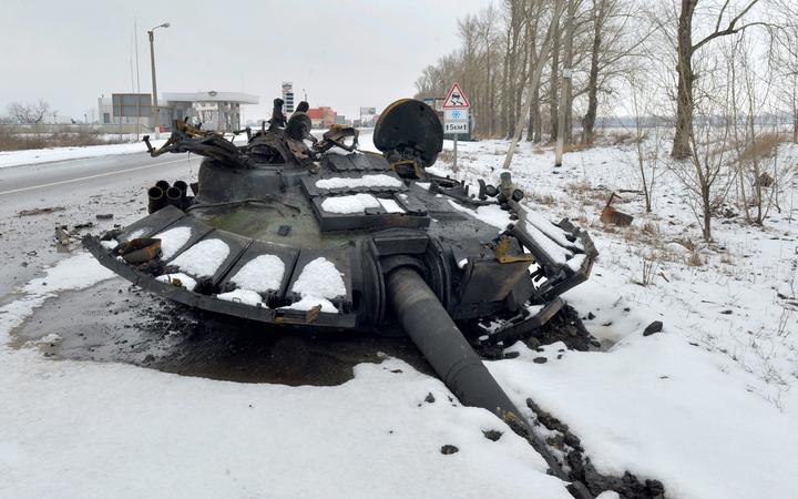 TOPSHOT - A fragment of a destroyed Russian tank is seen on the roadside on the outskirts of Kharkiv on February 26, 2022, following the Russian invasion of Ukraine. 