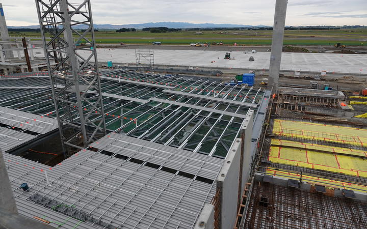 Roofs for the Ōhakea Air Force base aircraft hangars are being built on the ground. Cranes will hoist them into place.