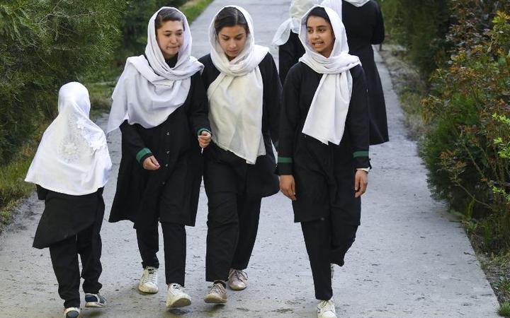 CAPTION ADDITION - updated information - 
Girls arrive at their school in Kabul on March 23, 2022. - The Taliban ordered girls' secondary schools in Afghanistan to shut on March 23 just hours after they reopened,