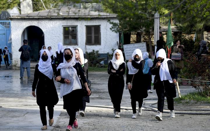 CAPTION ADDITION - updated information - 
Girls arrive at their school in Kabul on March 23, 2022. - The Taliban ordered girls' secondary schools in Afghanistan to shut on March 23 just hours after they reopened, an official confirmed, 