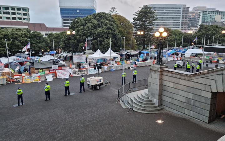 Police undertake an early morning operation to restore order and access to the area around Parliament.  