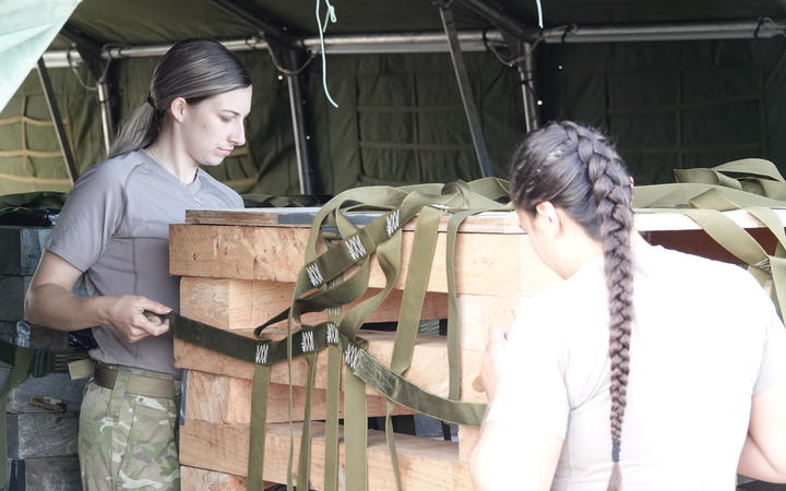 Army personnel rig together supplies to be dropped from aircraft during the training exercise.  