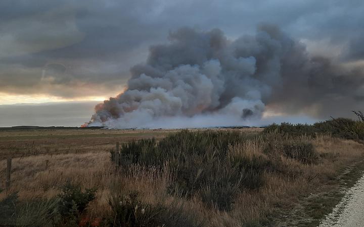 Smoke from a fire burning through 1000 hectares of manuka scrub and peat soils at Awarua, south of Invercargill, on 3 April, 2022.