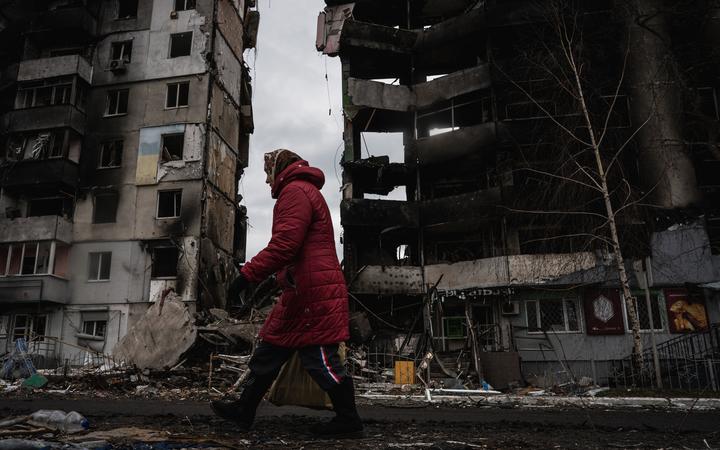 BORODIANKA, UKRAINE - APRIL 06: A woman walks past destroyed buildings after the Ukrainian army regained control of Borodyanka, Ukraine on March 06, 2022. 