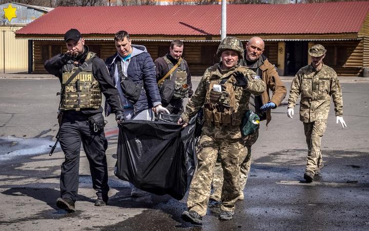 Ukrainian soldiers clear out bodies after a rocket attack killed at least 35 people on April 8, 2022 at a train station in Kramatorsk, eastern Ukraine, that was being used for civilian evacuations. 