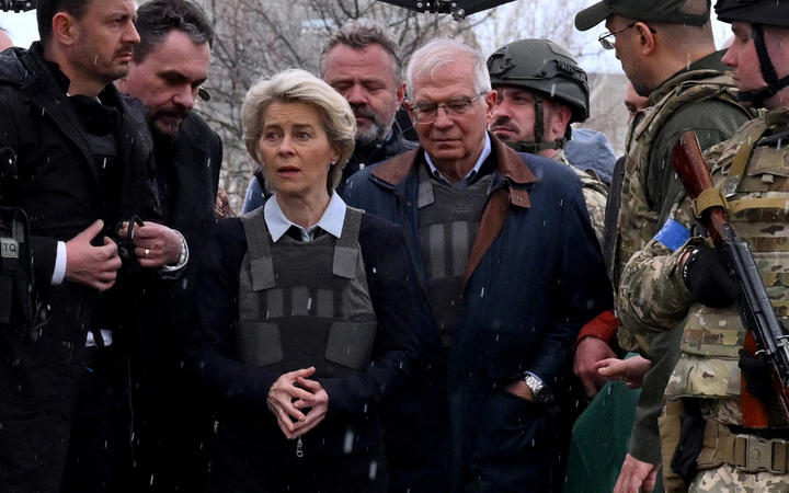 Slovakia's Prime Minister Eduard Heger (L) stands next to European Commission President Ursula von der Leyen, and European Union High Representative for Foreign Affairs and Security Policy Josep Borrell as they visit a mass grave in the town of Bucha, northwest of Kyiv on 8 April 2022. 