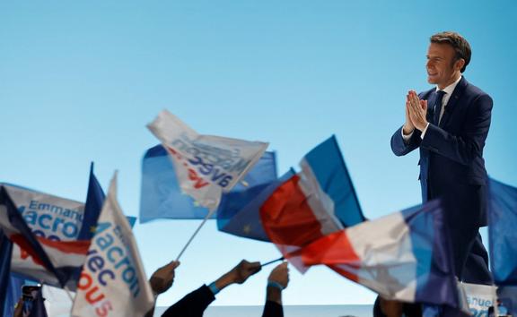 French President and La Republique en Marche (LREM) party candidate for re-election Emmanuel Macron gestures prior to addressing sympathizers after the first results of the first round of France's presidential election at the Paris Expo Porte de Versailles Hall 6 in Paris, on April 10, 2022. 