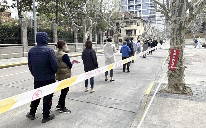 Local residents line to take PCR test under the lockdowns in Shanghai this month. The lockdowns are impacting on the economy, alongside Western sanctions against Russia.