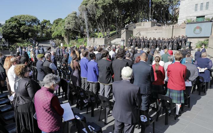 People stand during the National Commemoration Service at Pukeahu National War Memorial in Wellington.